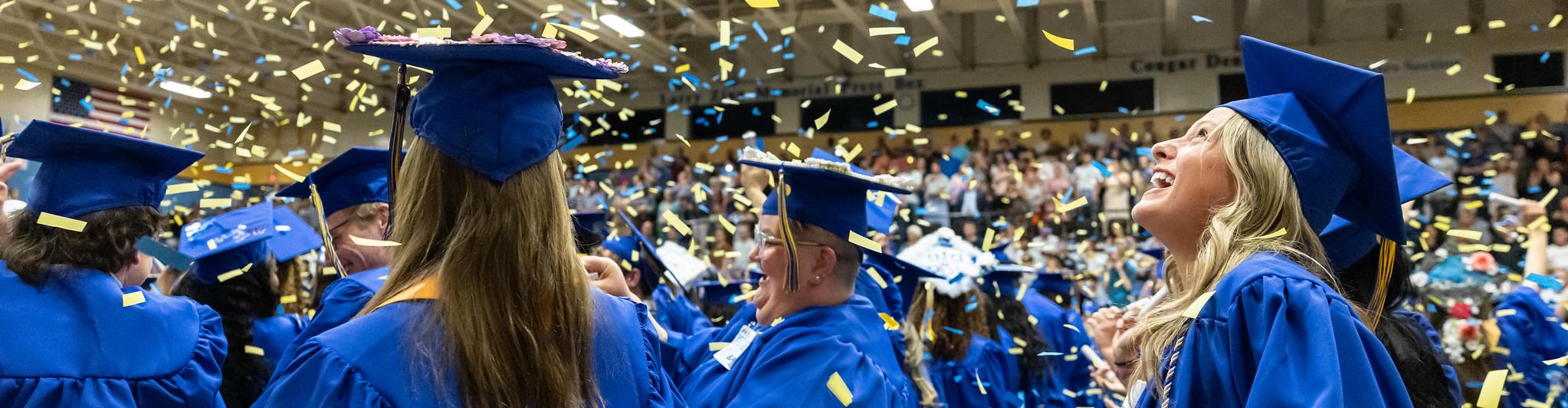 Students celebrate with confetti at the end of 2025 commencement